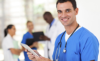 International nurse smiling with tablet